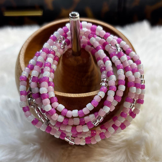 “Pink toned waist beads with delicate accents by Waisted By Design”