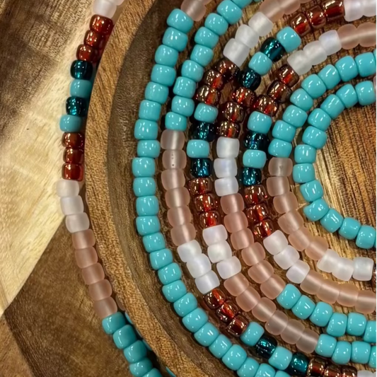 Elegant handcrafted waist beads featuring a refined blend of coastal-inspired tones symbolizing balance, movement, and modern feminine style.