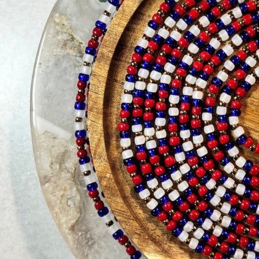 Colorful Juneteenth-inspired waist beads with vibrant red, green, gold, and black tones symbolizing freedom, resilience, and celebration.