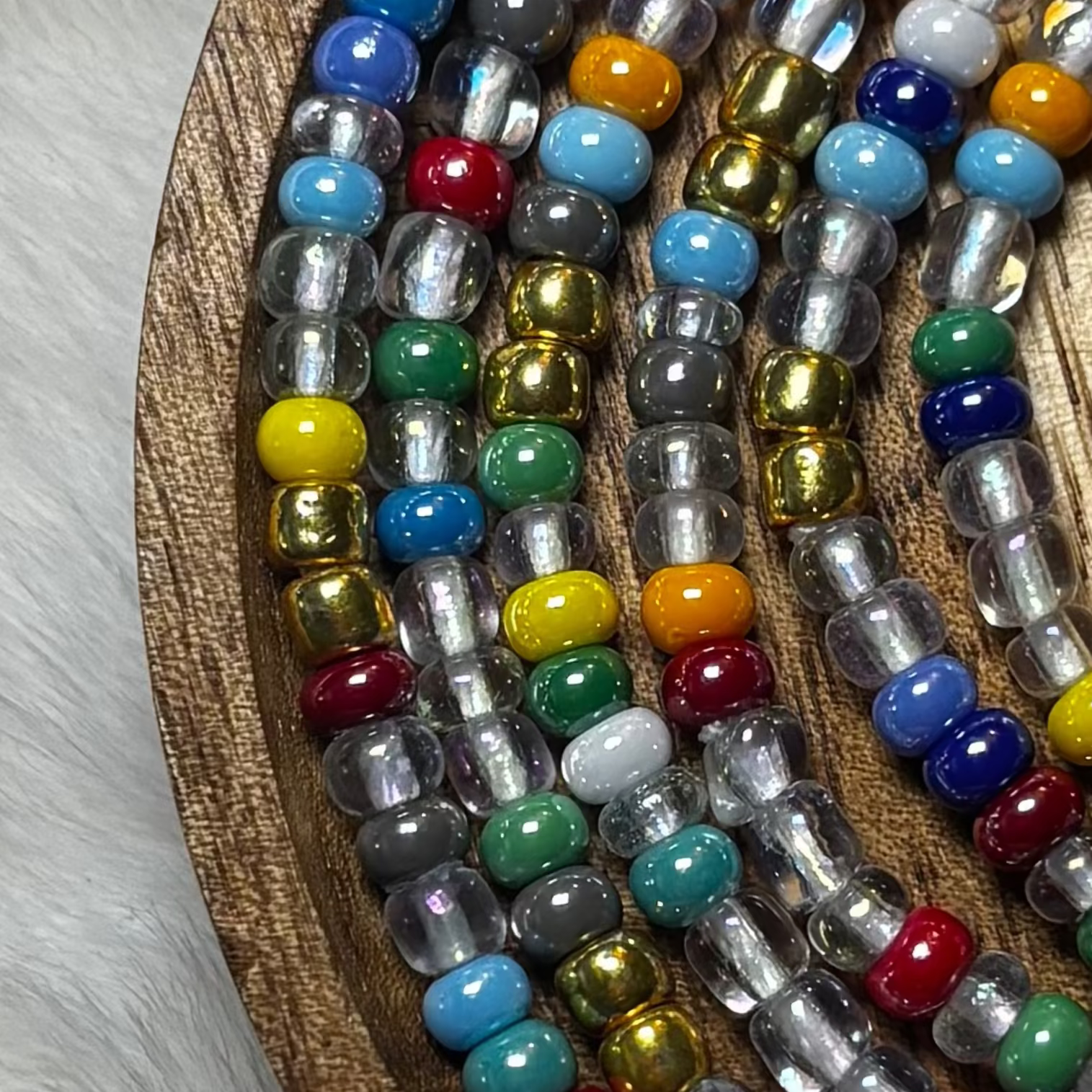 “Colorful mixed tone waist beads with muted rainbow hues by Waisted By Design”