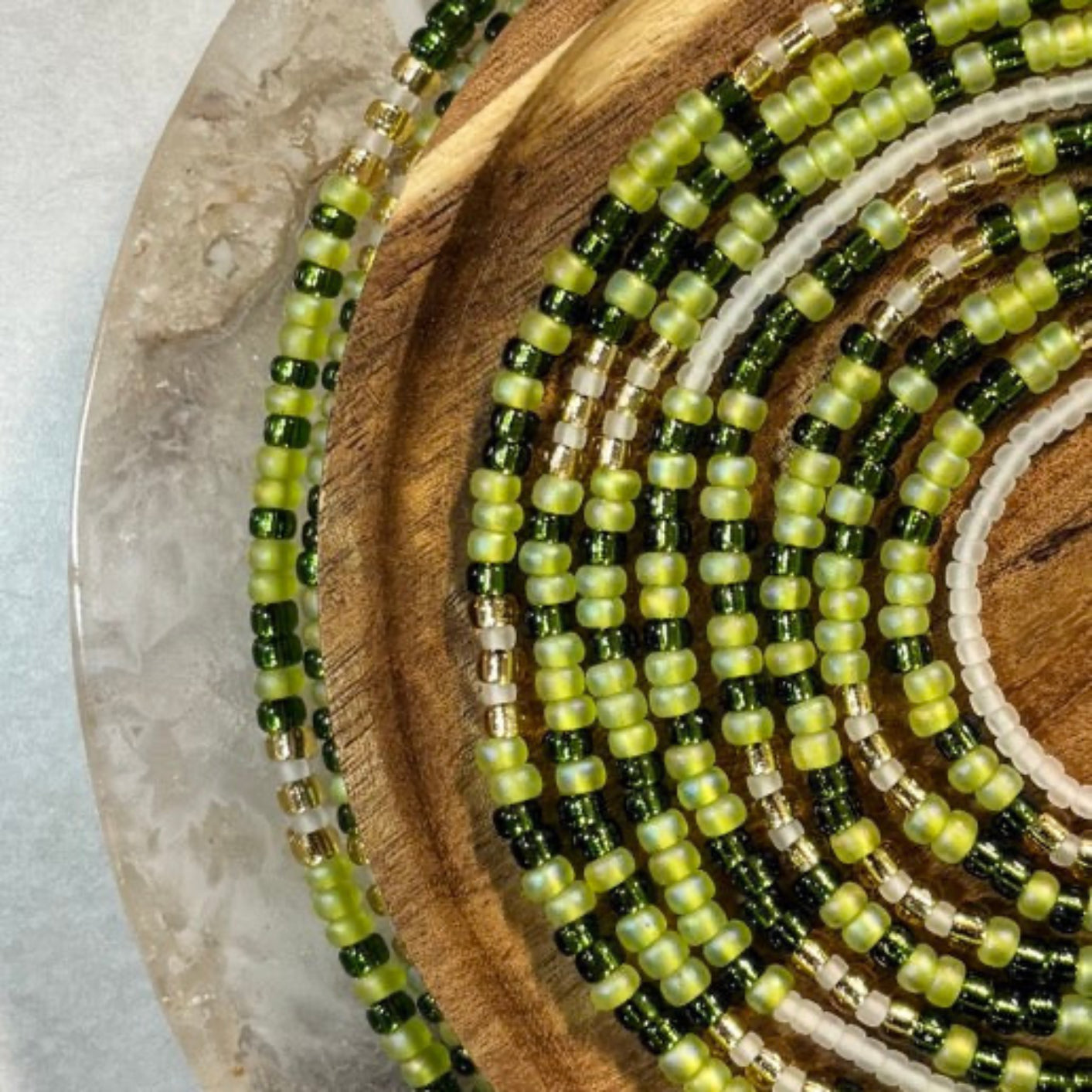Handmade green waist beads with jade tones symbolizing calm, balance, and feminine elegance.
