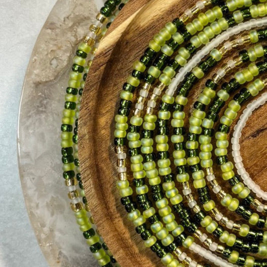Handmade green waist beads with jade tones symbolizing calm, balance, and feminine elegance.