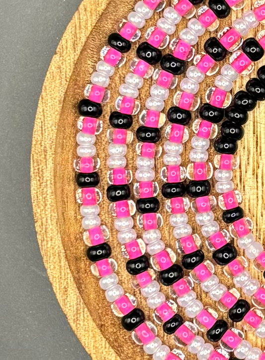 Midnight Doll from the Elevated Collection, featuring hot pink, black, and pearl seed beads in an intricate handcrafted waist bead design.